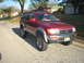 1996 Toyota 4Runner - Red 1996 Toyota 4Runner parked on a suburban street with houses in the background.