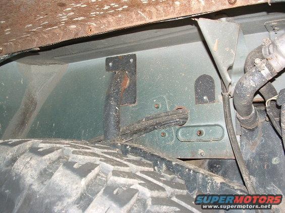 Close-up of vehicle underbody showing suspension components and tire tread