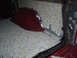 1978 Ford Bronco - Sound deadening material installed in the interior of a vehicle, showing a red carpeted section and foil backing.