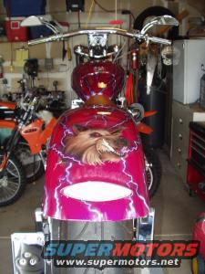 Motorcycle with custom paint job of a wolf and lightning bolts. Another motorcycle is visible to the left