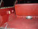 1978 Ford Bronco - The interior cargo area of a 1978 Ford Bronco shows red carpeting and a folded rear seat.