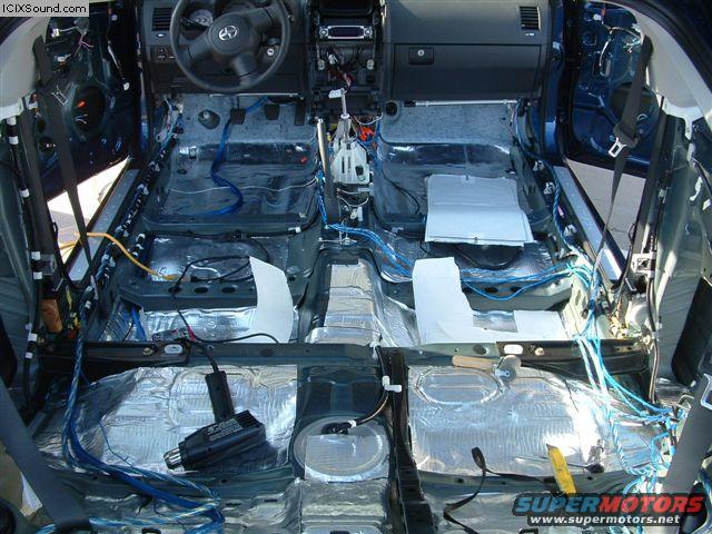 Car interior stripped down with sound deadening material and wiring