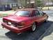 1995 Ford Crown Victoria - This 1995 Ford Crown Victoria sedan is shown from its rear quarter, highlighting its red paint and maroon vinyl top.