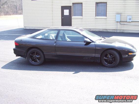 Dark 1993 Ford Probe GT coupe, side view, black wheels