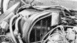 1978 Ford Bronco - A detailed view of engine components, including hoses and wiring, in a black and white photograph.