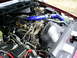 1995 Ford Crown Victoria - The engine bay of a vehicle, showing various components and blue intake piping.