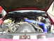 1995 Ford Crown Victoria - The engine bay of a red vehicle features prominent blue turbo piping and a 'Caution Fan' cover.