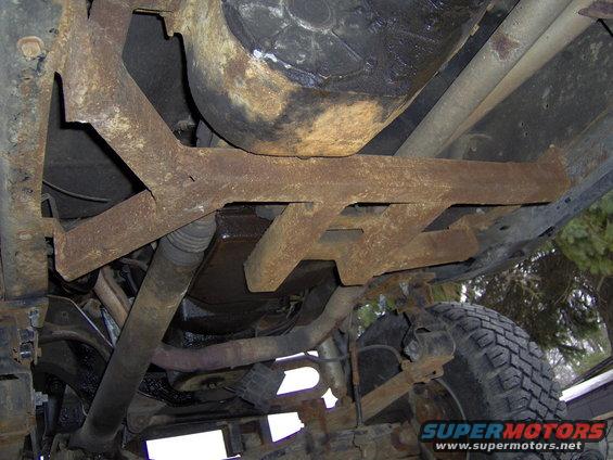 Undercarriage view of a 1986 Ford F-350 showing rusted frame components and suspension