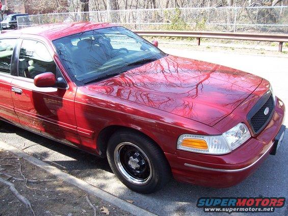 Red sedan, 3/4 front view. 1998 Ford Crown Victoria