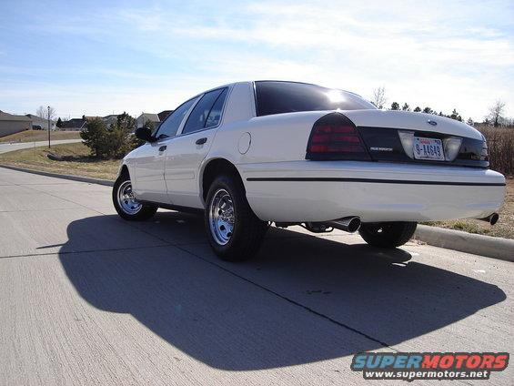 White 2000 Ford Crown Victoria rear view with aftermarket wheels