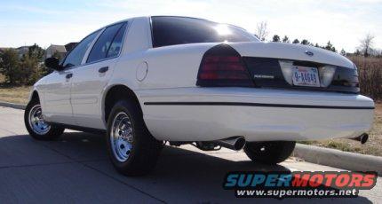 White 2000 Ford Crown Victoria rear quarter view with chrome wheels
