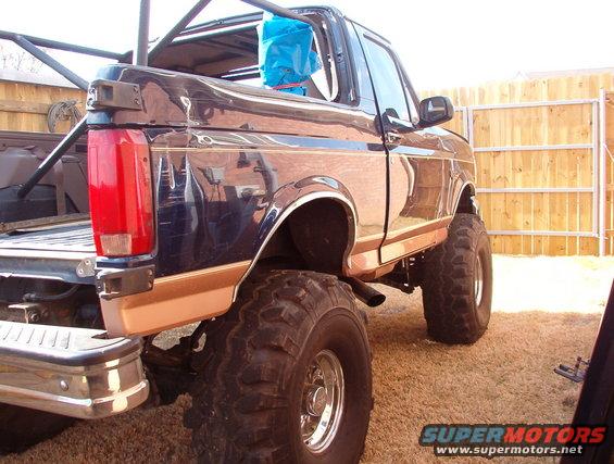 Lifted 1992 Ford Bronco with custom roll cage, viewed from the rear
