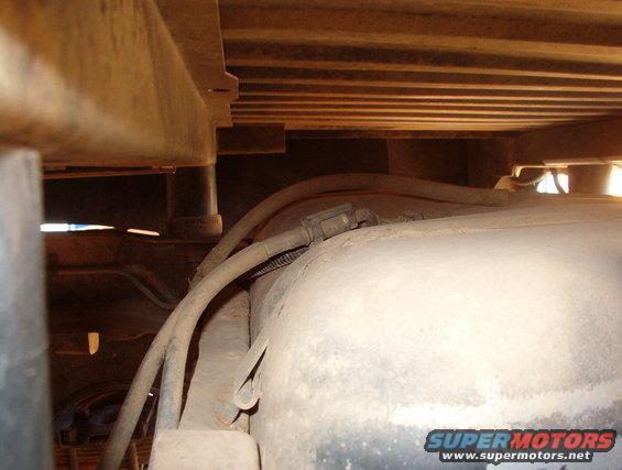 The fuel pump is just behind the bed floor reinforcement for the body mounts.