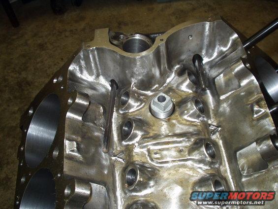 Close-up of an engine block's internal passages and bolt holes