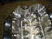 1990 Ford Mustang - The interior of a bare engine block shows machined surfaces and various threaded holes.