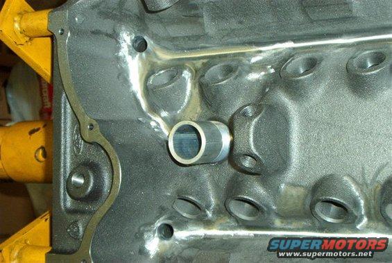 Engine block with metal tube fitting. Supermotors.net logo visible