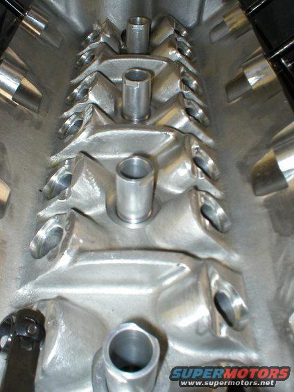 Close-up of an aluminum intake manifold with ports and raised bosses