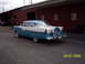 1960 Ford Falcon - Rear view of a classic two-tone blue and white sedan with a continental kit.