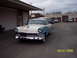 1960 Ford Falcon - This two-tone blue and white 1956 Ford Fairlane Crown Victoria is parked in front of a garage.
