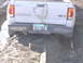 1981 Ford Bronco - Ford Ranger pickup truck with 4x4 badging is stuck in a muddy area, with a tow strap visible.
