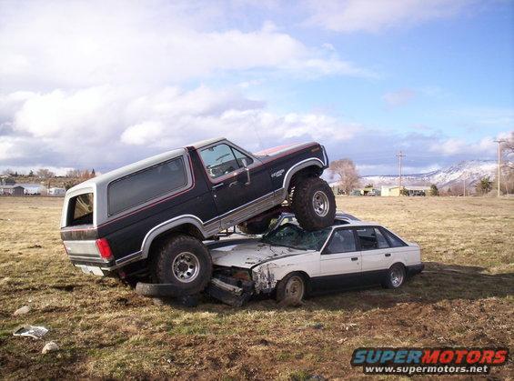 1984 Ford Bronco crushing a sedan, 3q-front view