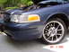 1998 Ford Crown Victoria - A blue Ford Crown Victoria is shown from the front quarter with its hood up and custom wheels.