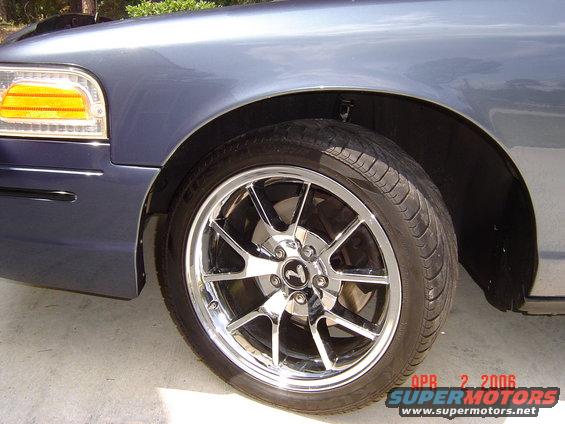 Blue 1998 Ford Crown Victoria front fender and chrome wheel