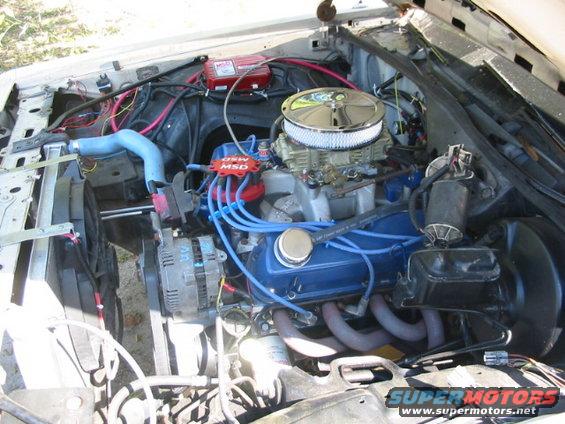 Engine bay showing a V8 engine with a chrome air cleaner, blue valve covers, and MSD ignition components