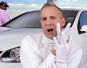 Man in white lab coat and gloves, with a white car behind him