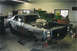 1978 Dodge Monaco - Car body undergoing restoration in a workshop with tools and shelves in the background.