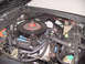 1978 Dodge Monaco - Close-up view of a car's engine bay, showing the air cleaner, valve covers, and various engine components.