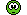 Pixelated green cartoon character with one large black eye and a small mouth, against a white background