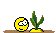 Pixelated smiley face and plant on a brown surface