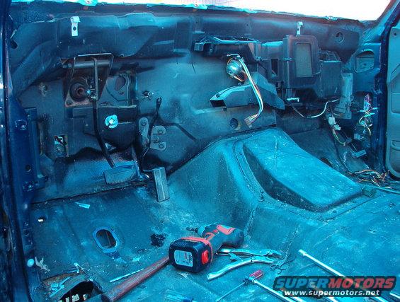 42ldash.jpg The silver thing above the brake pedal is the steering shaft extension for the body lift.  The 2 white clips at the top of the firewall are for the driver's door harness that runs all the way over to the passenger kick area.