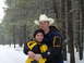 1991 Ford Bronco - A couple embraces in a snowy forest, dressed in warm winter gear.