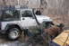 1995 Jeep Cherokee - Off-roading Jeep Wrangler gets stuck in the mud, requiring assistance from bystanders.