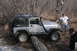 1995 Jeep Cherokee - A silver Jeep Wrangler Rubicon is seen off-road, equipped with a snorkel and roof rack, with two men nearby.