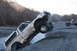 1995 Jeep Cherokee - An off-road pickup truck is stuck in a ditch while another vehicle watches.