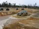 2004 Dodge 2500 - Several ATVs and a lifted SUV navigate a muddy off-road course.
