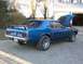 1969 Ford Mustang - This blue 1969 Ford Mustang is parked outside a garage with its hood up.