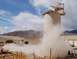 1979 Ford Bronco - A large silo releases a significant dust plume into the air at a construction or industrial site.