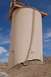 1979 Ford Bronco - A large, beige industrial silo appears damaged at its base, with a ladder running up its side under a clear blue sky.
