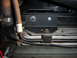 1996 Ford Bronco - A bracket is attached to the radiator fan shroud, with a hose and wiring nearby.