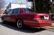 1999 Ford Crown Victoria - Rear 3/4 view of a red 1999 Ford Crown Victoria parked on a residential street.