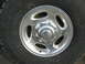 1996 Dodge 2500 - Close-up of a chrome Dodge Ram wheel with a Ram logo center cap and a Goodyear Wrangler tire.
