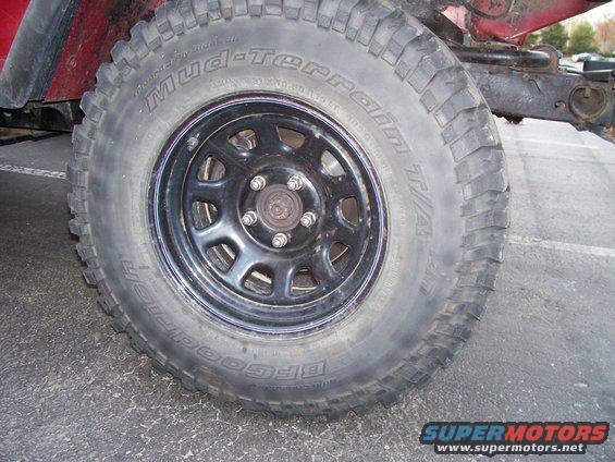 BFGoodrich Mud-Terrain T/A tire on a black Jeep wheel, showing part of the red body
