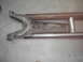 1978 Ford Bronco - Close-up of a rusty radius arm and suspension components, likely from a vehicle.