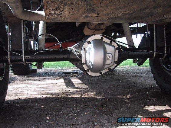 Rear axle differential with silver cover and bolts, undercarriage of a vehicle