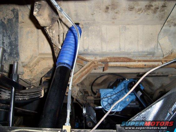 Undercarriage view of a blue shock absorber boot and a blue component