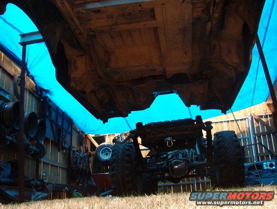 Underbody of vehicle with large tires, suspended for work